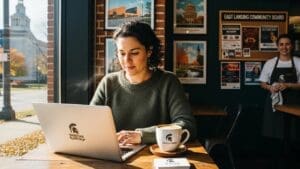 Small business owner designing a website in a cozy East Lansing café